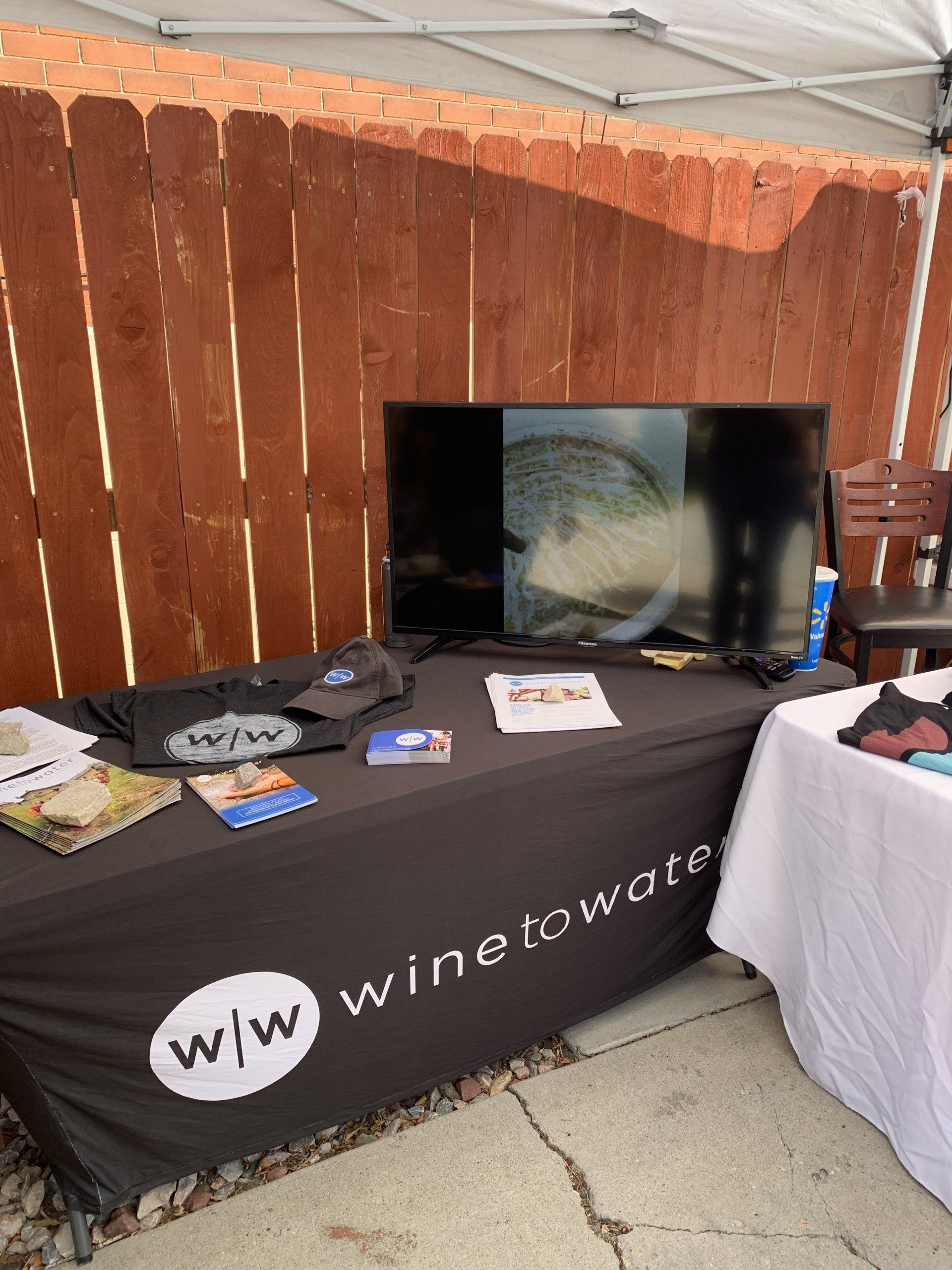 A table with a black table cloth that says wine to water on it