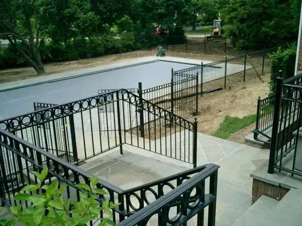 Stairs Leading Up To A Swimming Pool With A Fence Around It — Albertson, NY — Patsy Strocchia & Sons Ir
