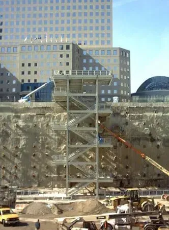 A Construction Site With A Large Building In The Background — Albertson, NY — Patsy Strocchia & Sons Ir
