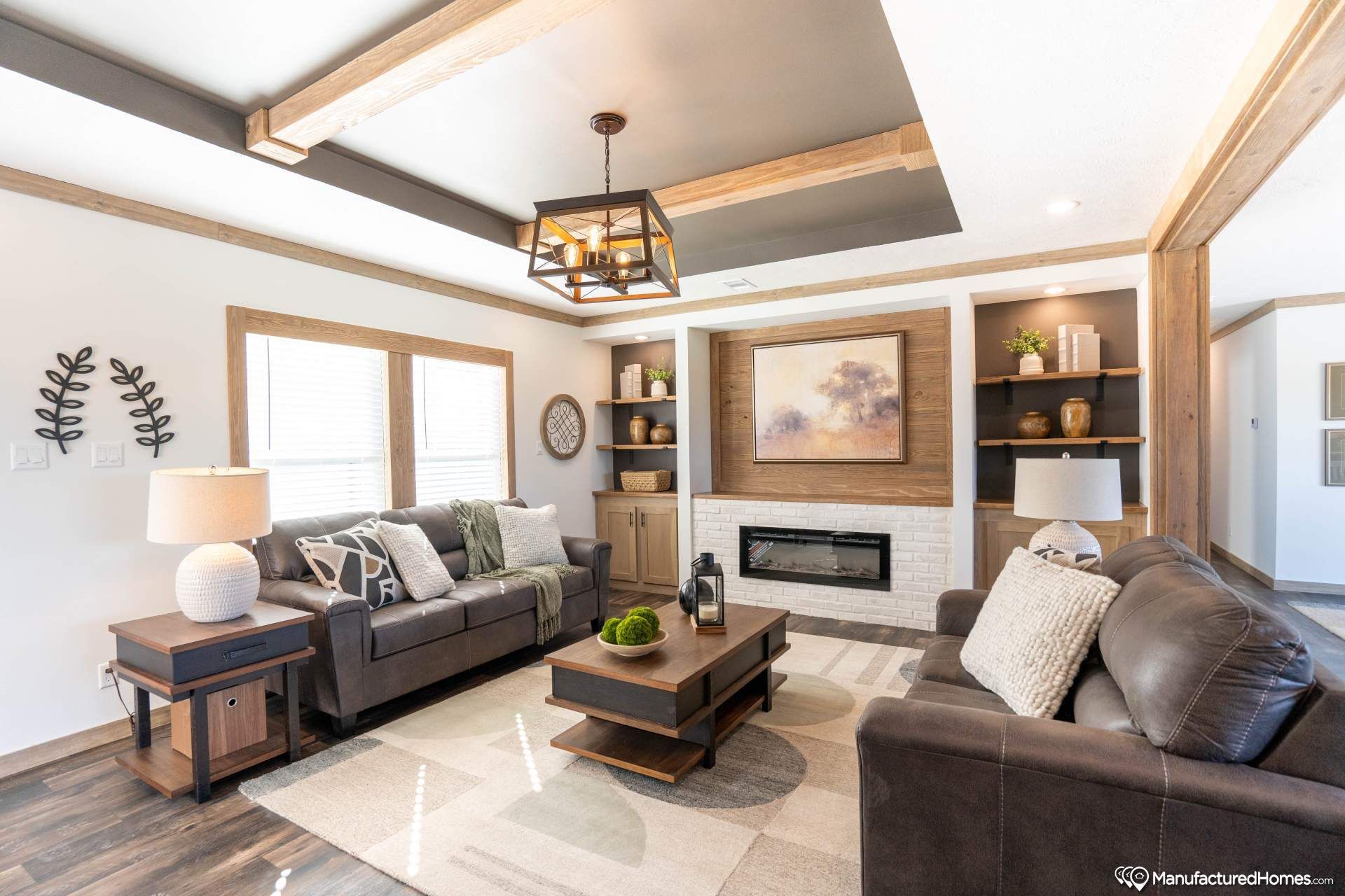 A living room with two couches , a coffee table , and a fireplace.