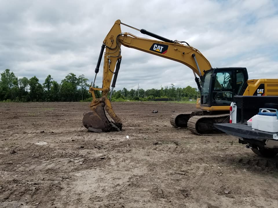 excavator clearing land for mobile home
