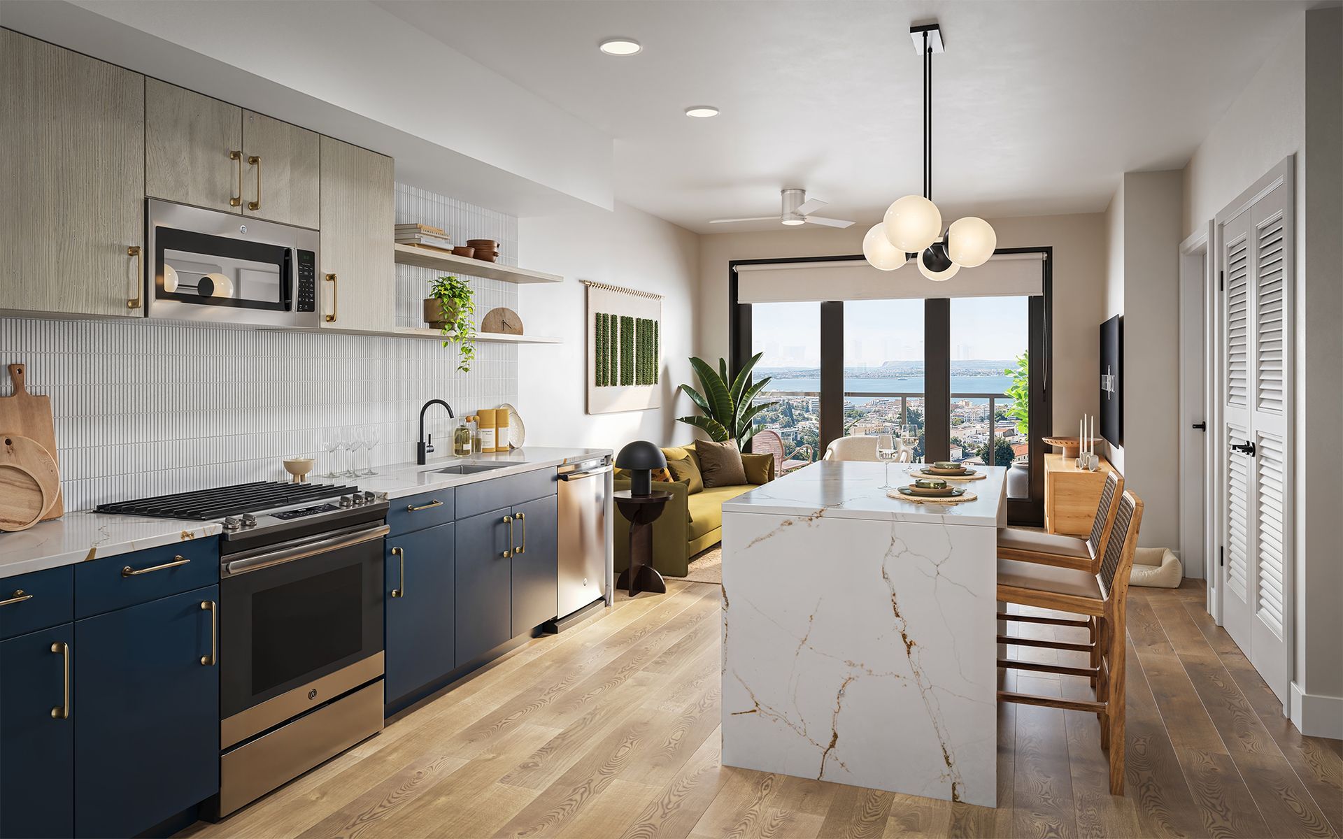 Modern apartment kitchen with blue cabinets, marble island, and city view.
