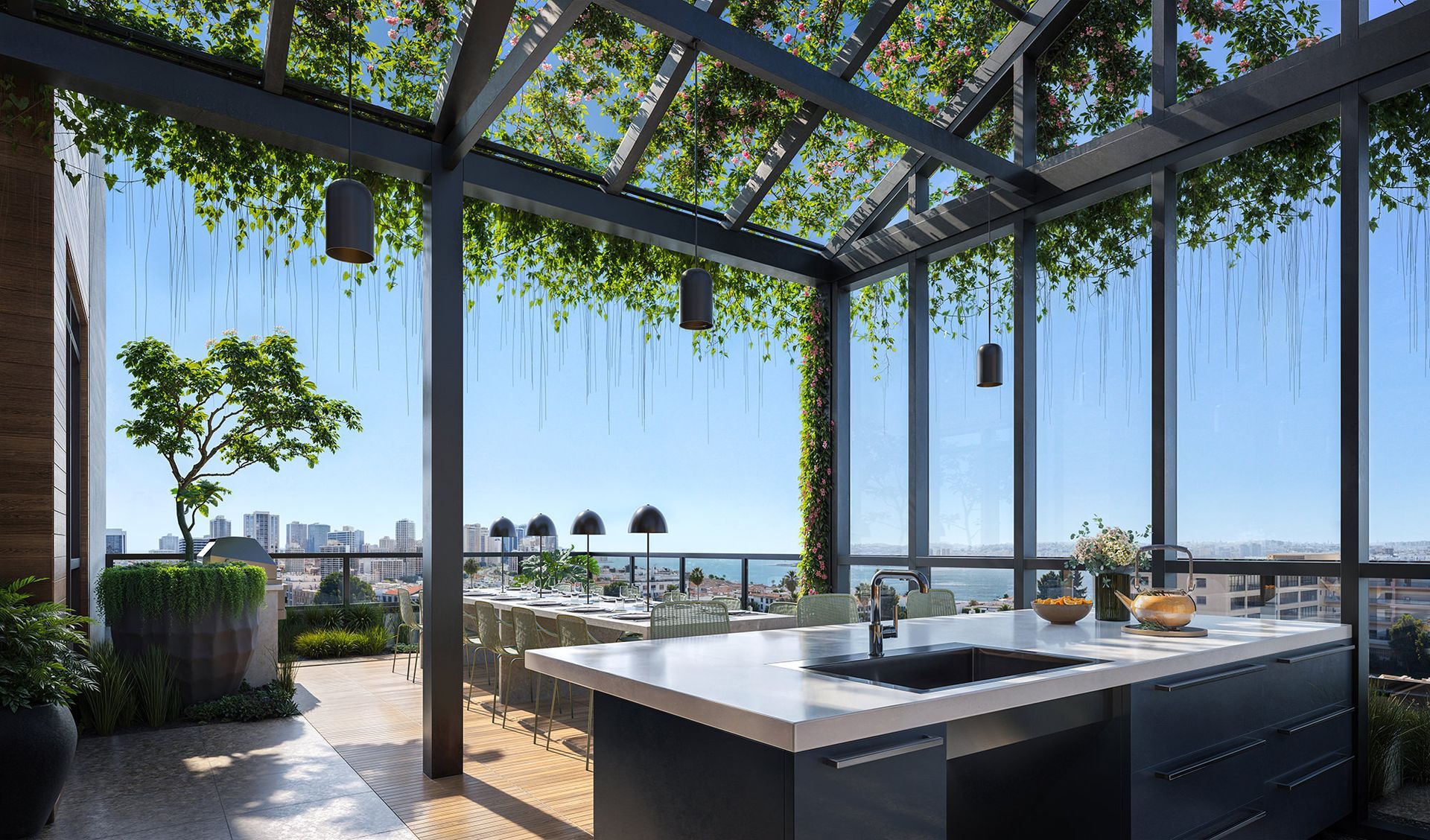 Rooftop kitchen with a view of the sea, featuring a dark countertop island, dining table, and climbing plants.