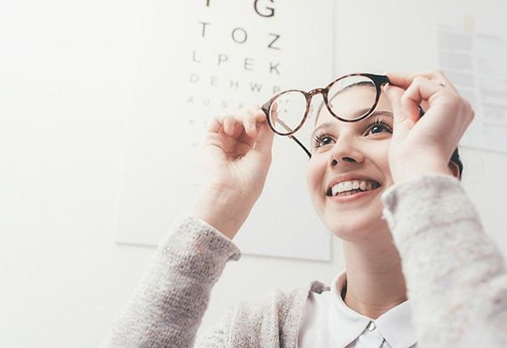 Woman trying her new glasses — Munster, IN — Munster Eye Care Associates