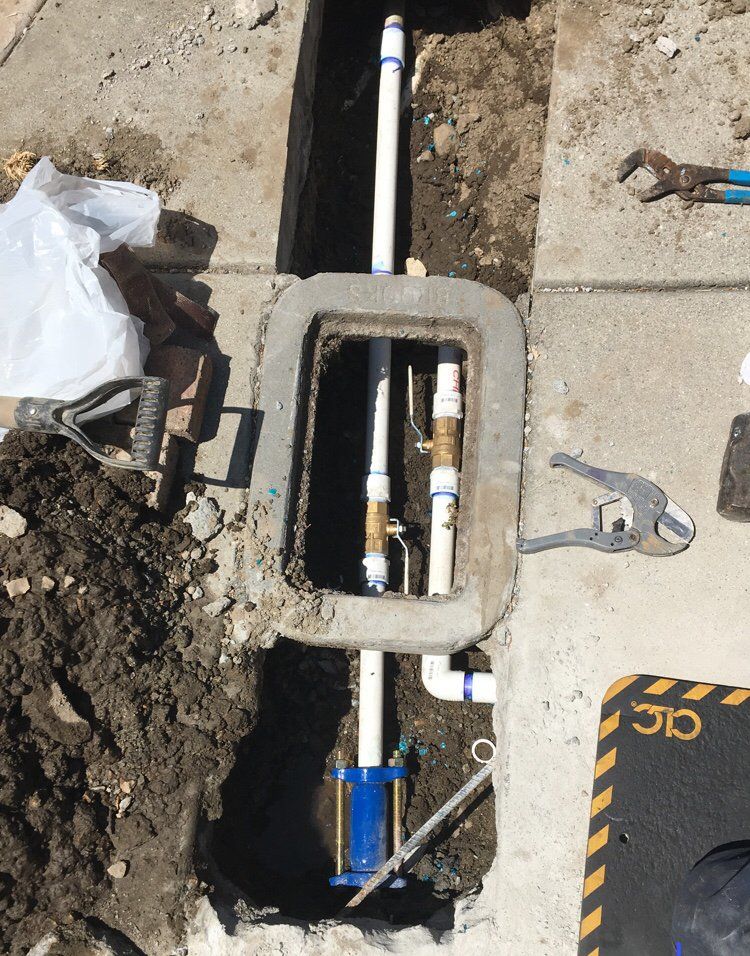 A pipe is being installed in a hole in the ground