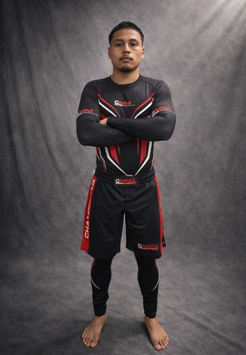 Two people practicing Brazilian Jiu-Jitsu on a mat. One is on top, applying a hold.