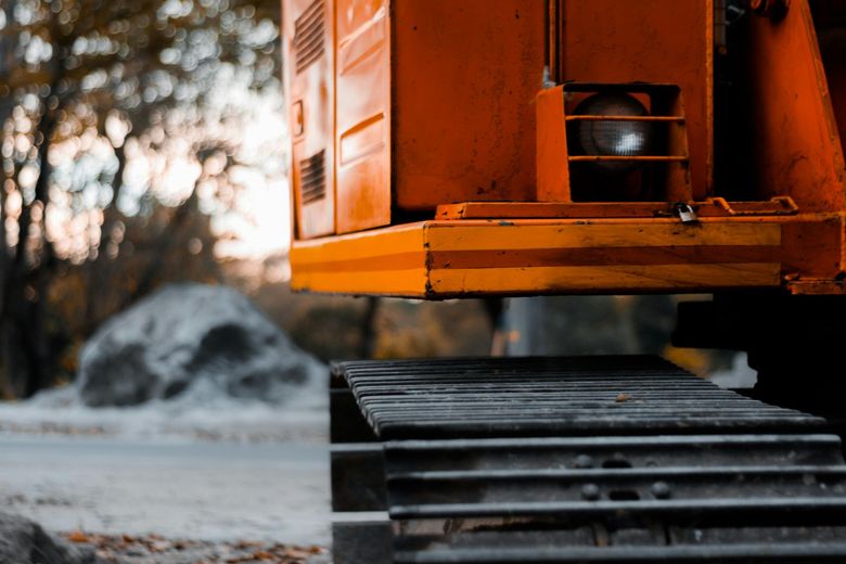A close up of a bulldozer 's track on a construction site.
