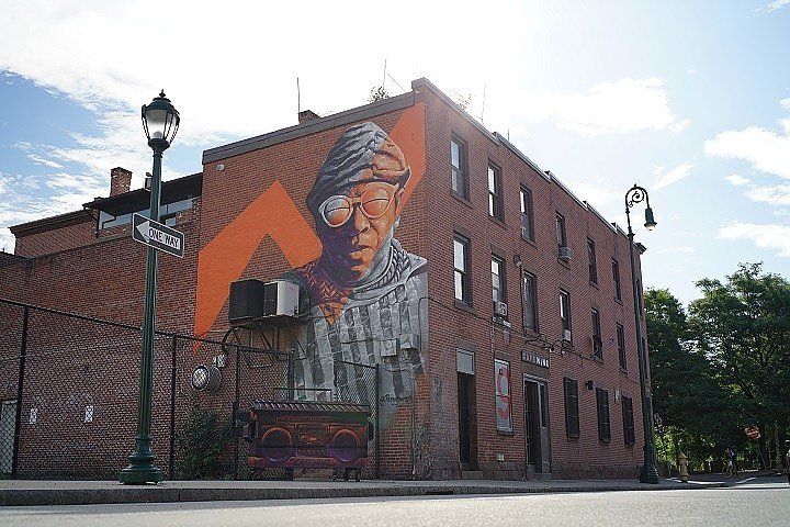 Paul Mayer, owner of Cafe Nine on the corner of State and Crown, looked up at the mural of jazz legend Sun Ra that now graces the side of the building that houses his bar.