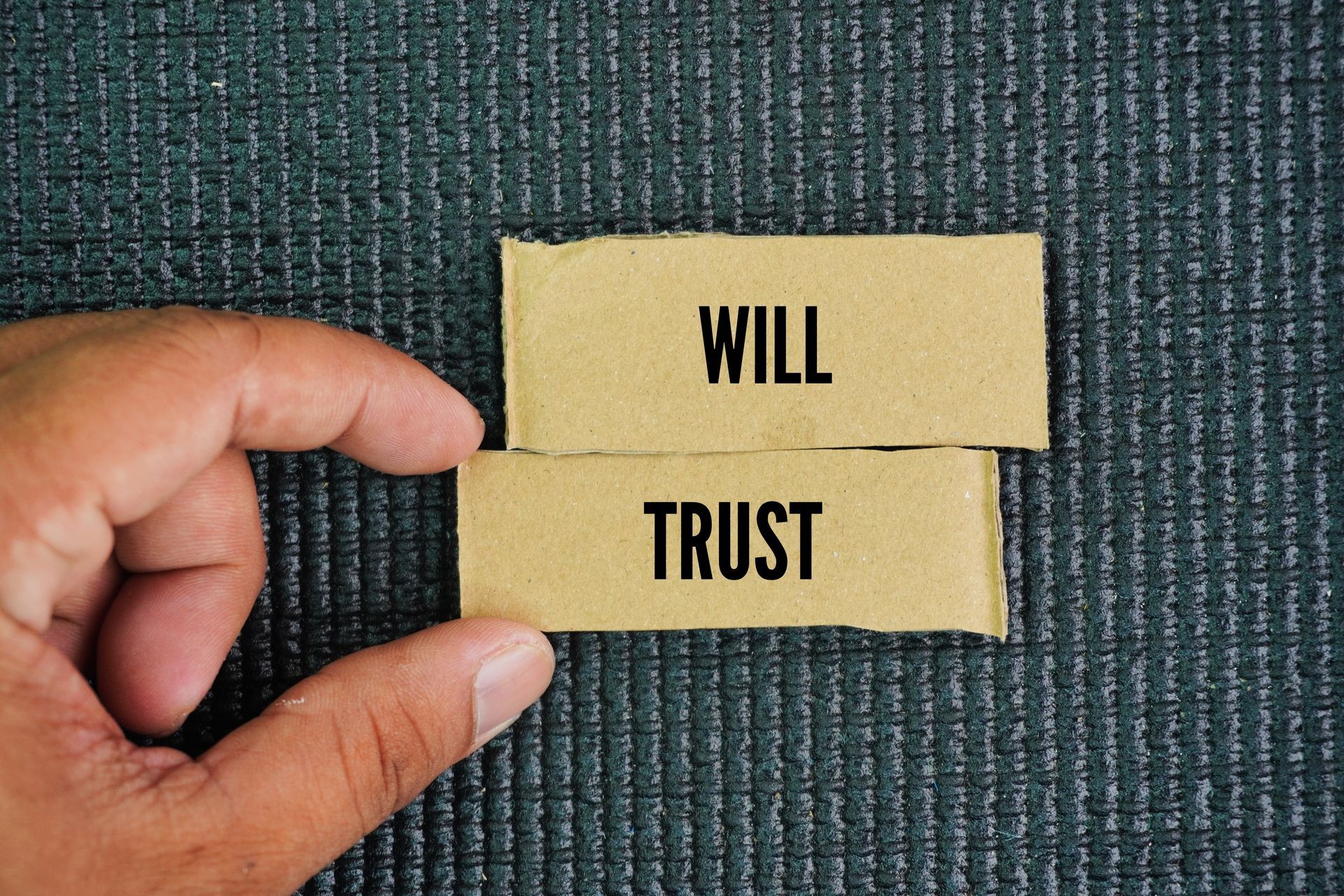 Papers labelled “will” and “trust” representing an estate planning decision Papers labelled “will” and “trust” representing an estate planning decision