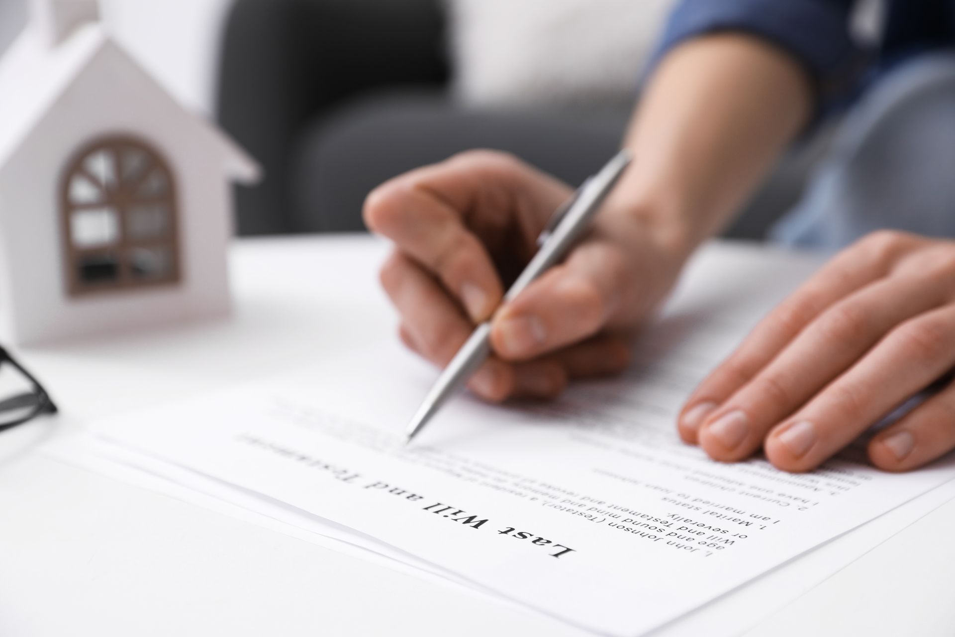 Woman signing ‘Last Will’ document depicting the Estate Planning process