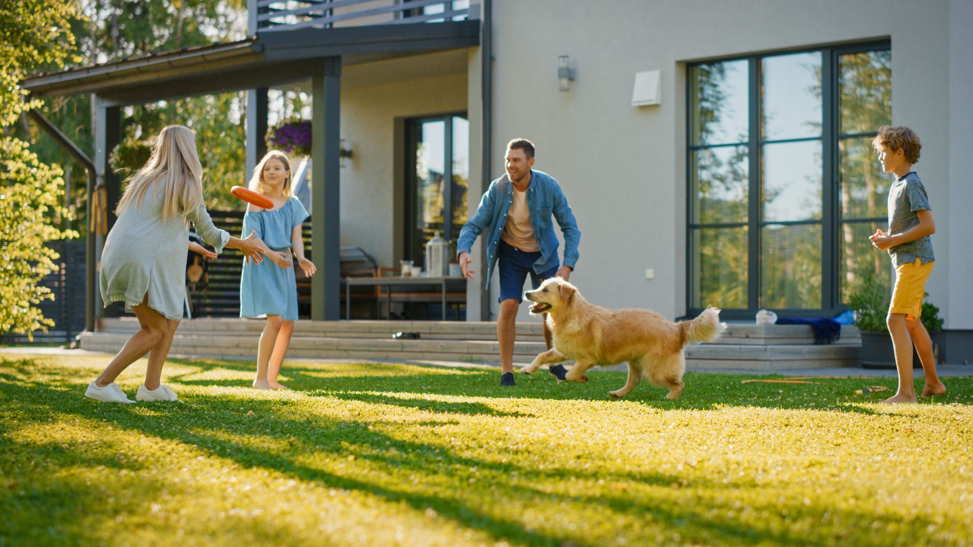 Family playing with their dog on the backyard
