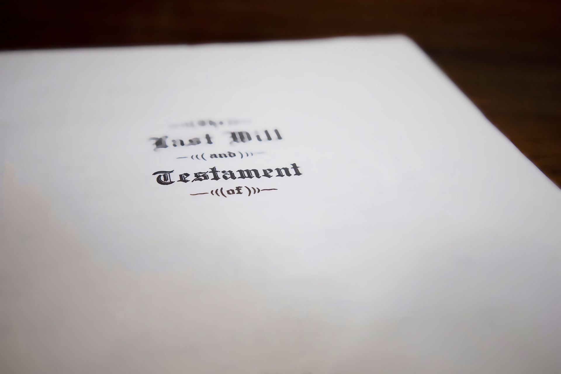 A close-up of a last will and testament document on a table, with text partially blurred in focus