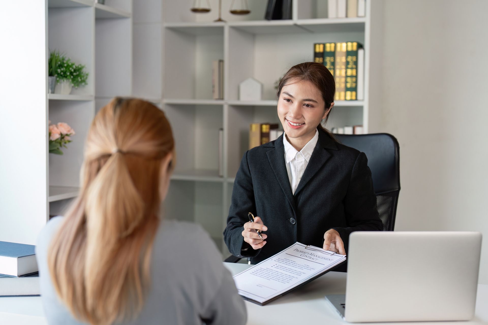 A lawyer offers expert legal advice to a client in a contemporary office setting A lawyer offers expert legal advice to a client in a contemporary office setting