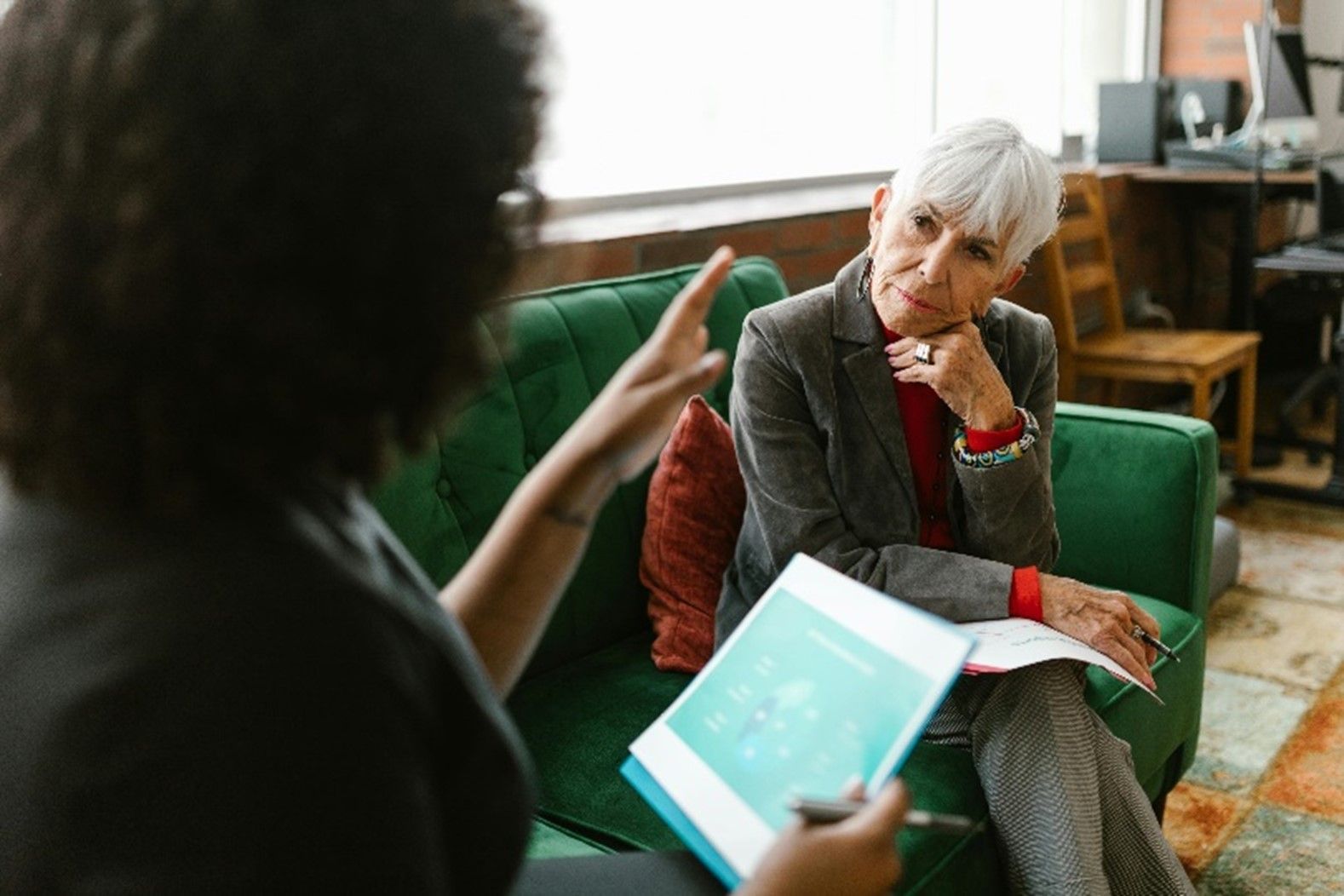 A lawyer is explaining a will to a senior woman.