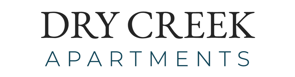 Logo for Dry Creek Apartments. The words DRY CREEK in black are over the word APARTMENTS in a teal color.