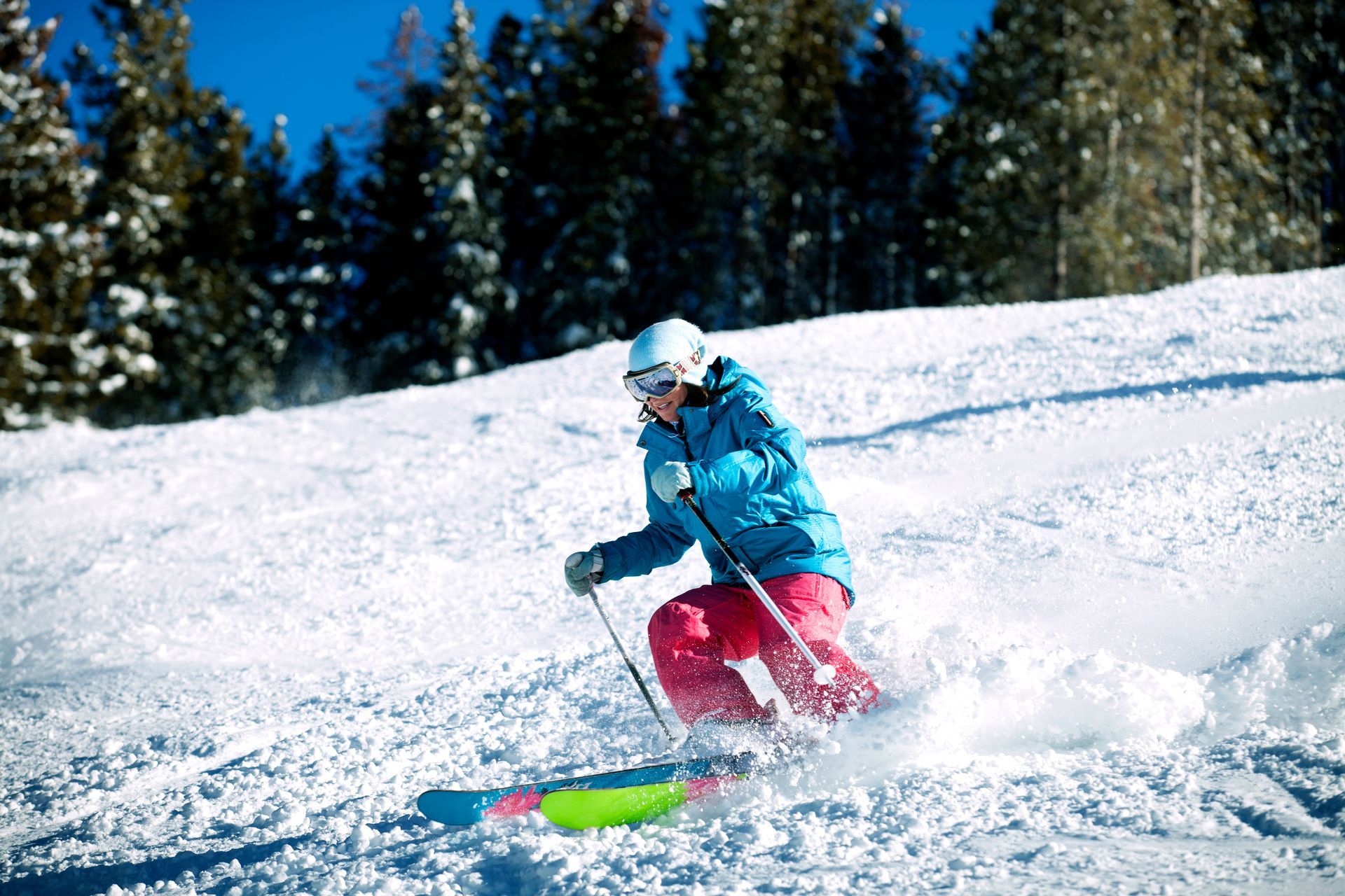 A person is skiing down a snow covered slope.