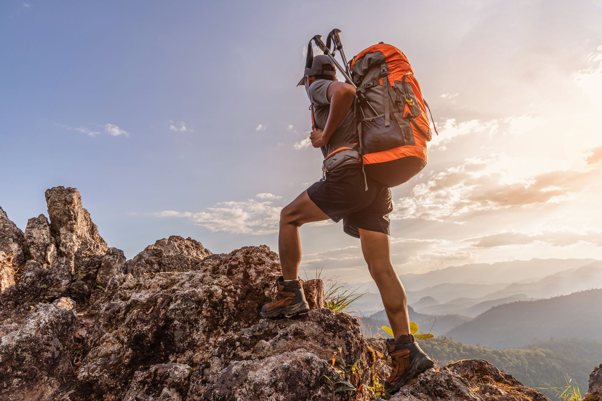 A man with a backpack is climbing a mountain.