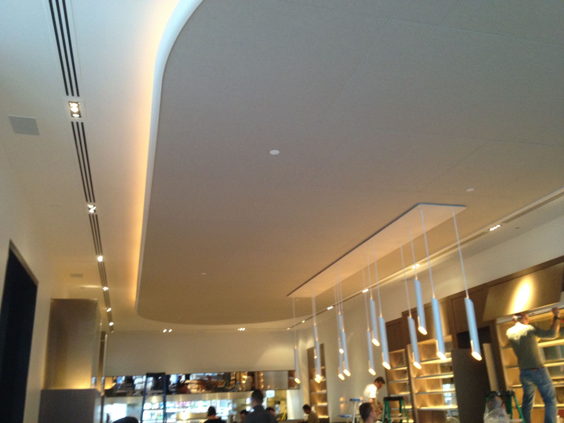 A restaurant with a ceiling that has a lot of lights hanging from it