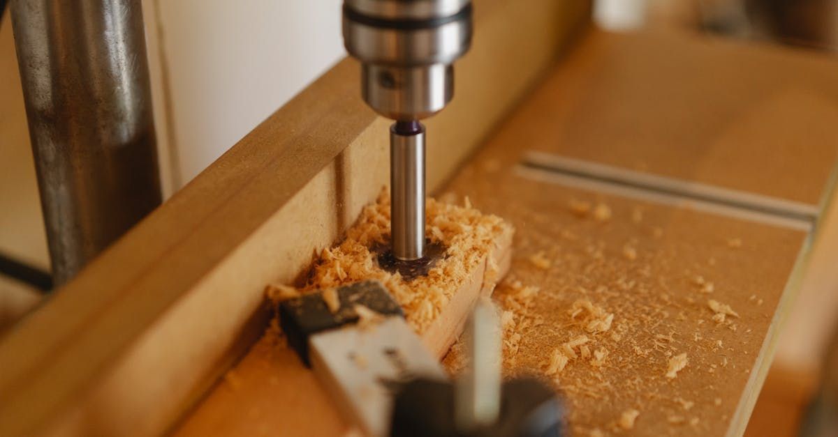 A person is drilling a hole in a piece of wood.