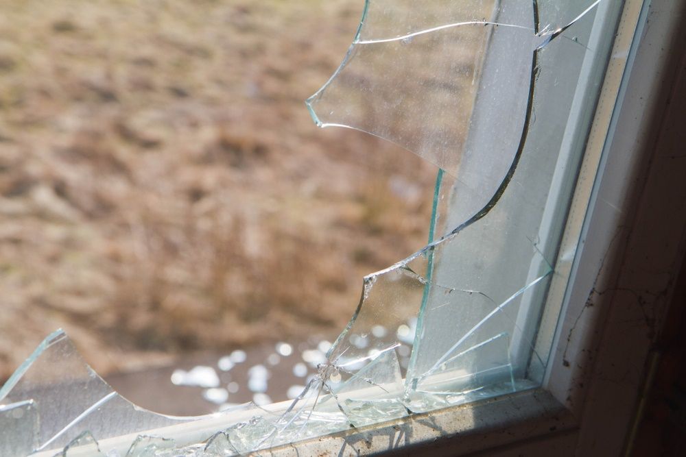 A Close Up of a Broken Glass Window in a House — Tuggerah Lakes Glass In Tumbi Umbi, NSW