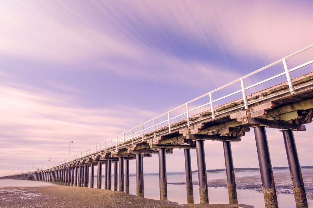 A Long Wooden Pier With a Railing Over a Body of Water — Tuggerah Lakes Glass In Long Jetty, NSW