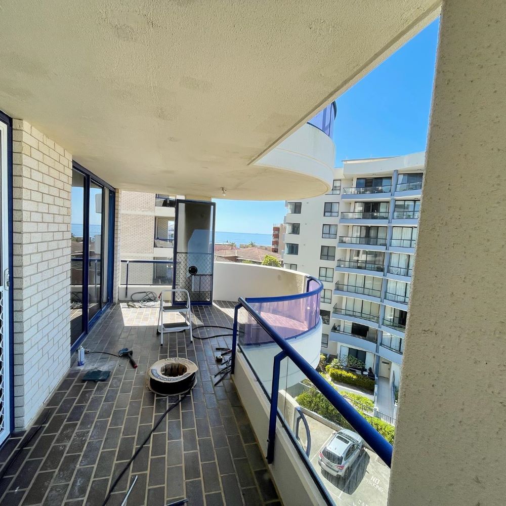 A Balcony With a View of a Building and the Ocean — Tuggerah Lakes Glass In Woy Woy, NSW