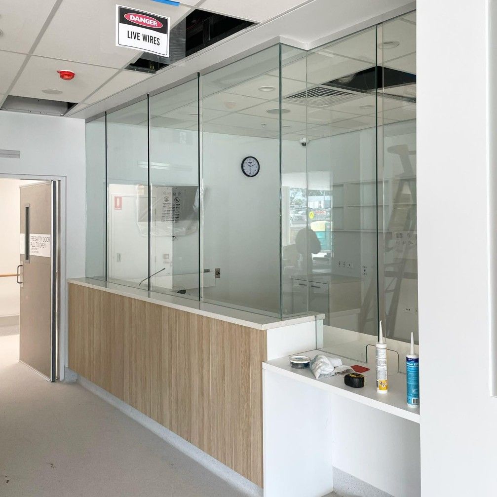 A Room With a Lot of Glass Walls and a Clock on the Wall — Tuggerah Lakes Glass In Tumbi Umbi, NSW