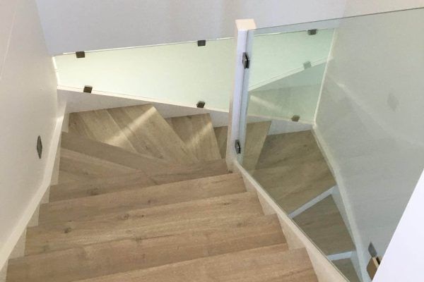 A Wooden Staircase With a Glass Railing in a House — Tuggerah Lakes Glass In Tumbi Umbi, NSW
