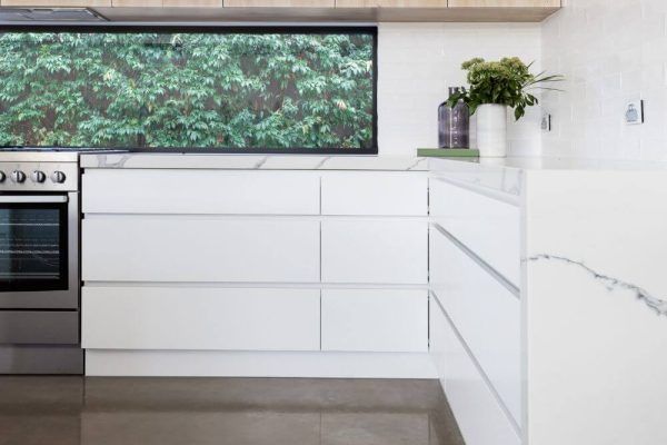 A Kitchen With White Cabinets , a Stove , and a Window — Tuggerah Lakes Glass In Tumbi Umbi, NSW