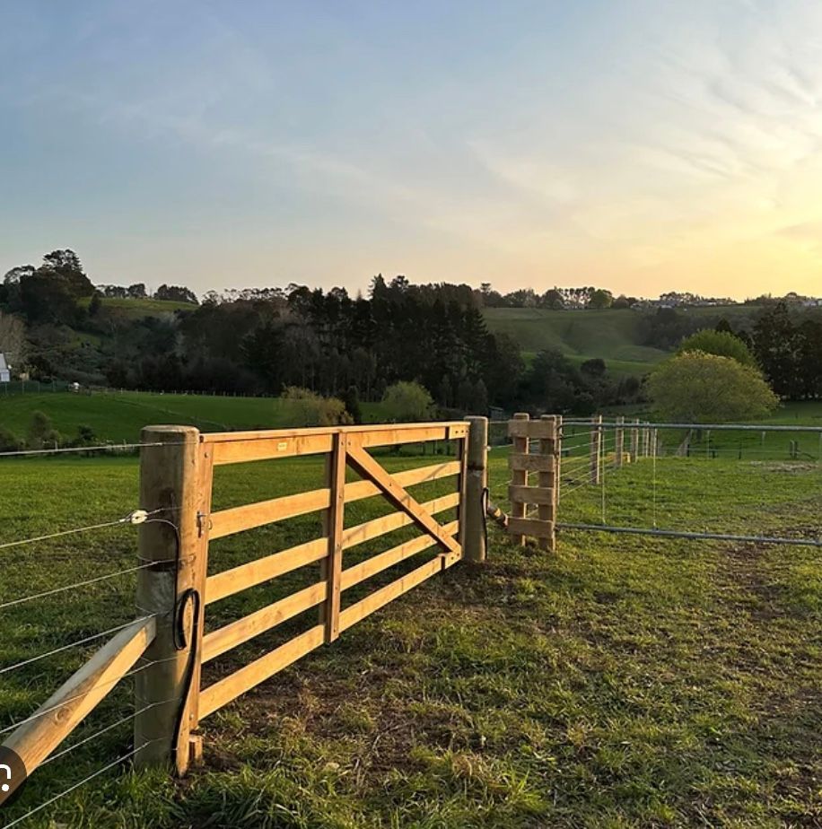 A Wooden Fence is in the Middle of a Grassy Field — Fencing Around Town Townsville in Garbutt, QLD