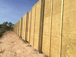 A Wooden Fence Along a Dirt Road With Trees in the Background — Fencing Around Town Townsville in Garbutt, QLD