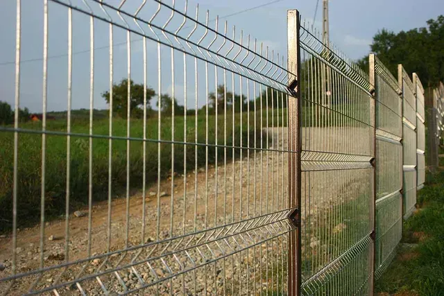 A Metal Fence Surrounds a Dirt Road in A Field — Fencing Around Town Townsville in Garbutt, QLD