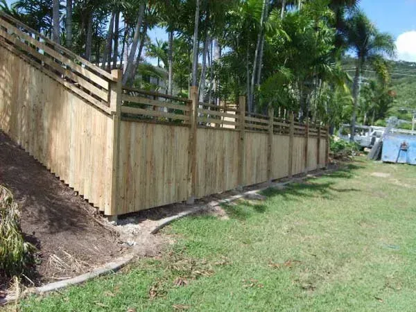 A White House with A Wooden Fence Around It  — Fencing Around Town Townsville in Garbutt, QLD