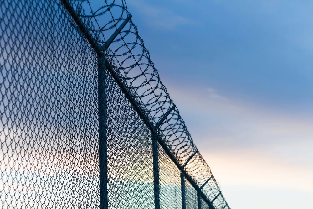 A Barbed Wire Fence With a Blue Sky in the Background — Fencing Around Town Townsville in Garbutt, QLD