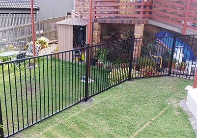 A Swimming Pool With A Green Fence Around It — Fencing Around Town Townsville in Garbutt, QLD