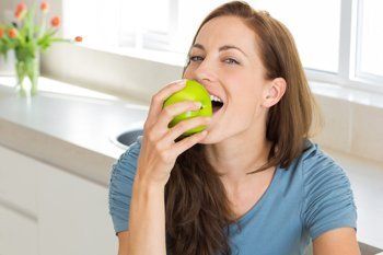 Teen Eating a Green Apple — Indianapolis, IN — Hollander, Jay A