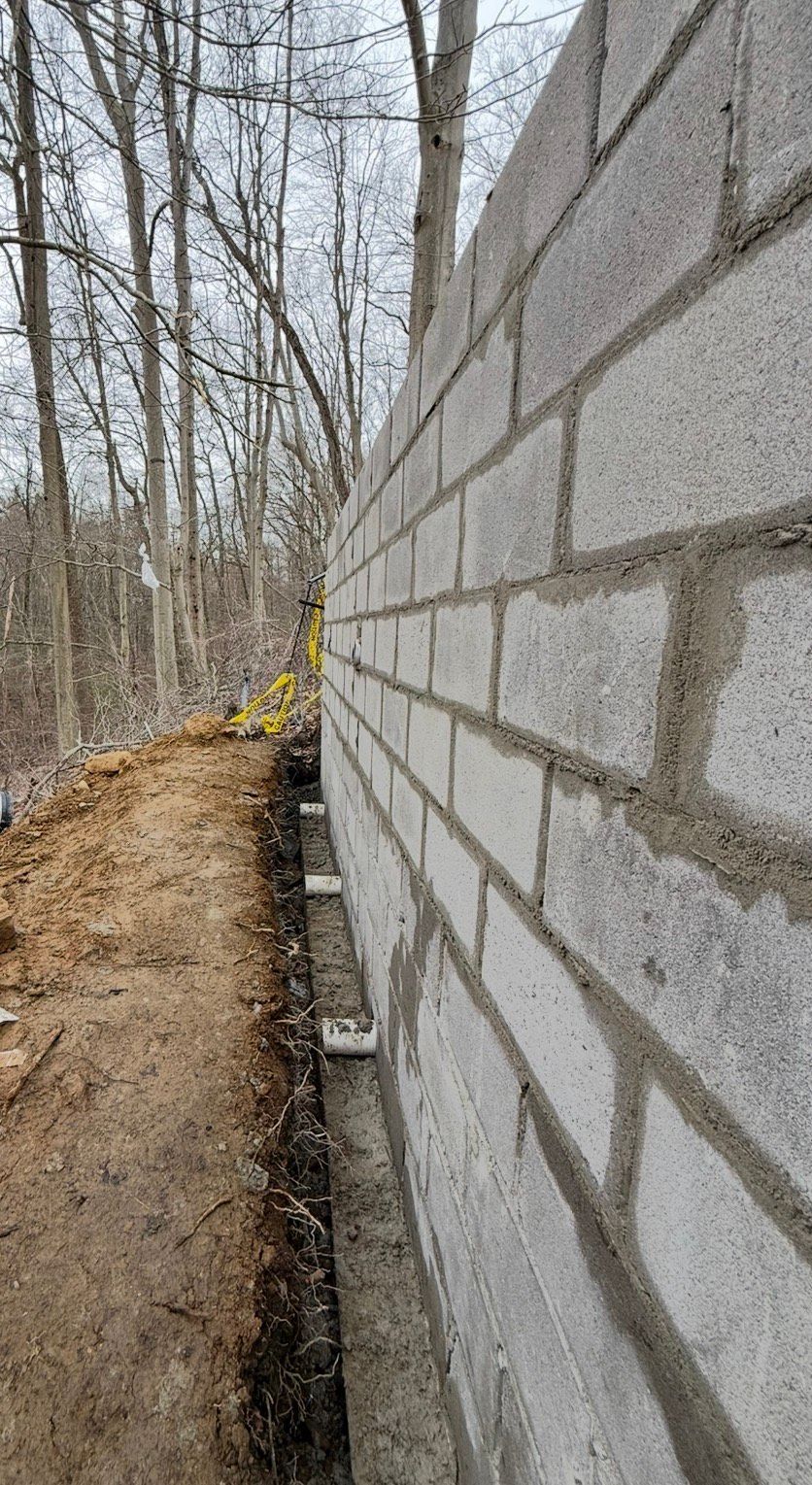Spiral staircase with stainless steel handrail, speckled stone steps, looking down.