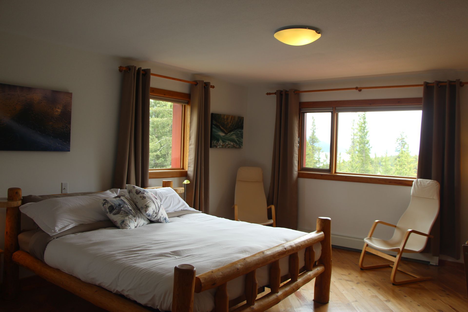 A bedroom with a large bed and a rocking chair