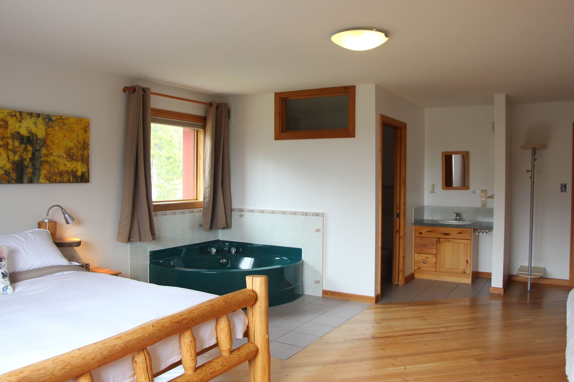 A bedroom with a bed and a jacuzzi tub