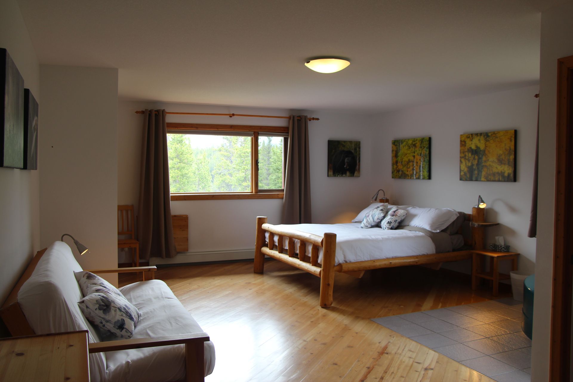 A bedroom with a large bed and a couch.