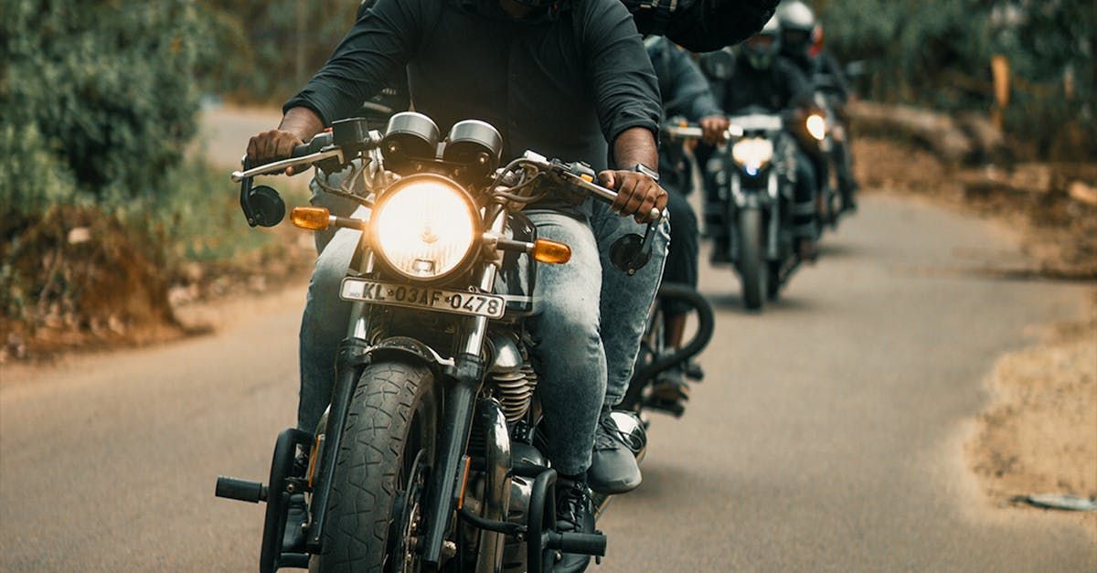 A group of people are riding motorcycles down a road.