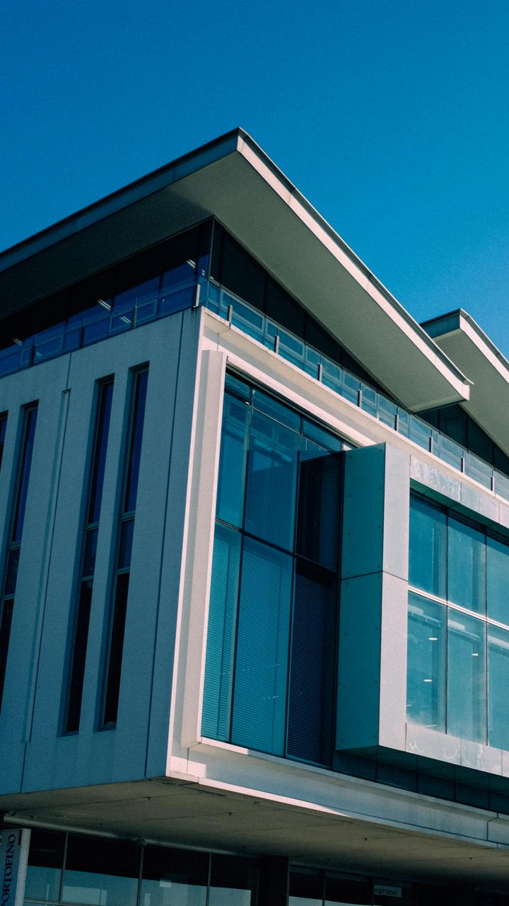 A man is sitting on a couch using a laptop computer.