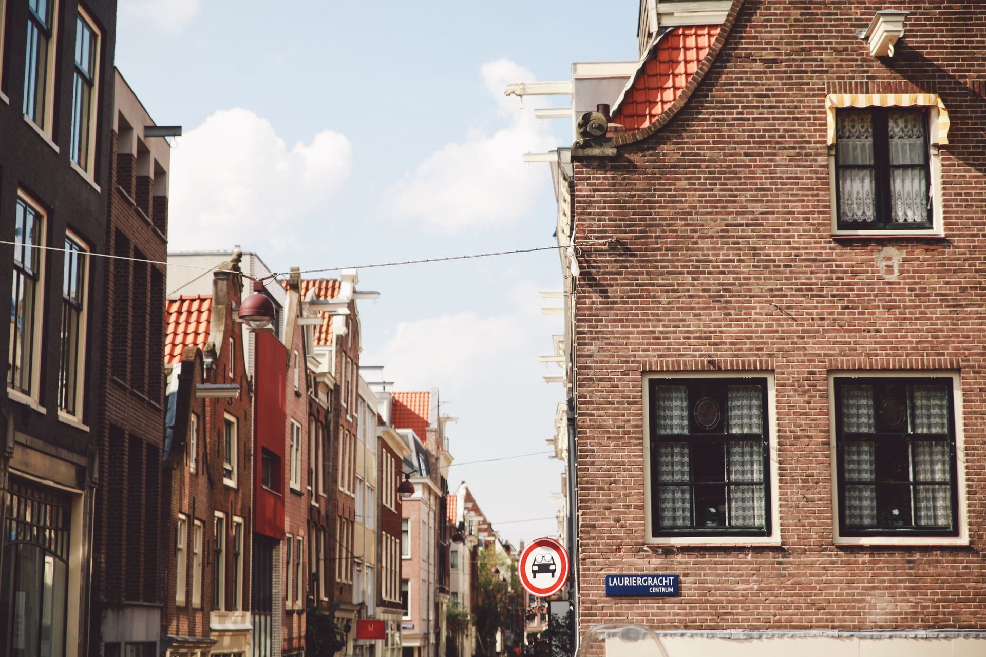 A brick building with a no parking sign on the side of it.