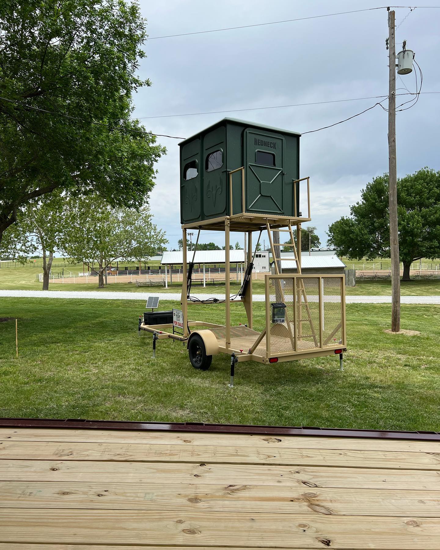 Image of a Redneck Hunting Blind mounted on a Top Game hydraulic hunting trailer
