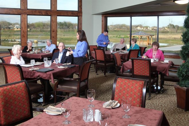 A group of people are sitting at tables in a restaurant