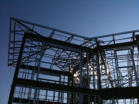 A building under construction with a blue sky in the background