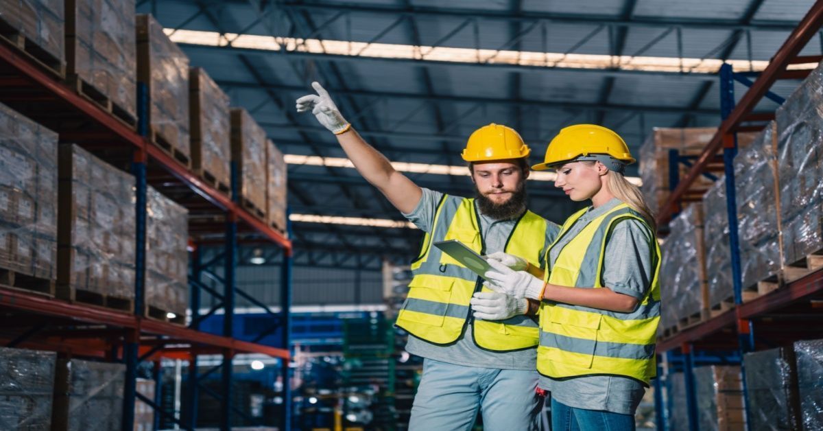 Warehouse workers using a tablet after Business Central migration.