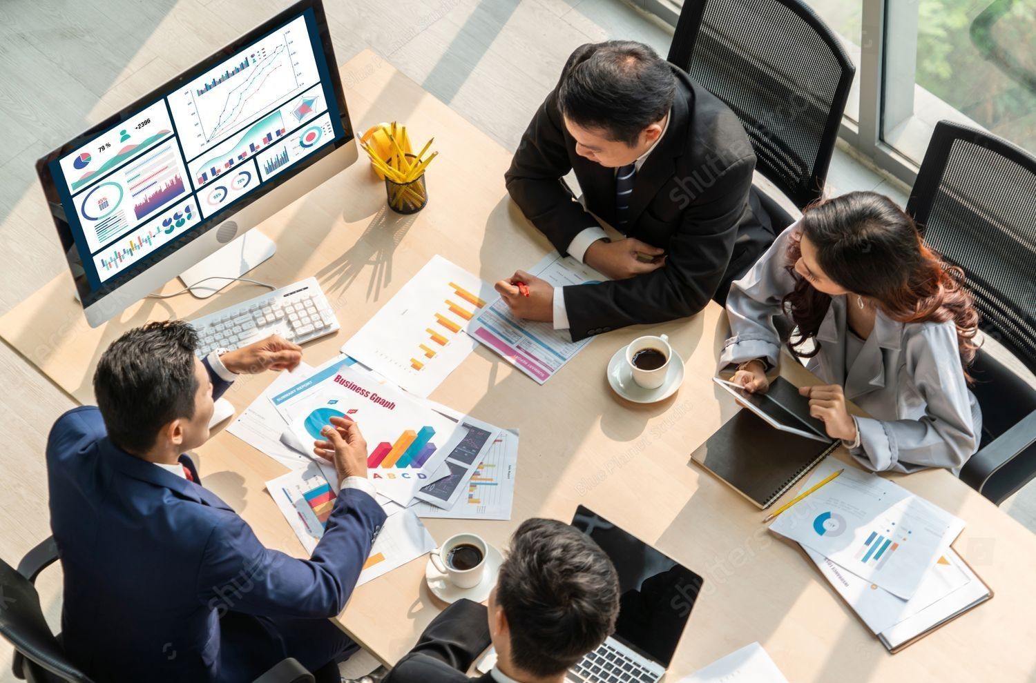 Four people looking stressed at laptops with text: 