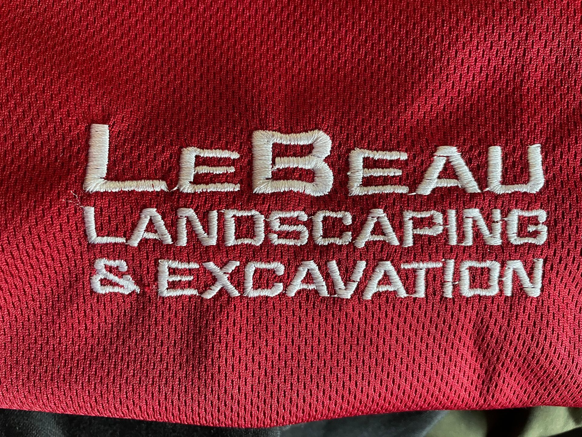 White embroidery on a red background reads 