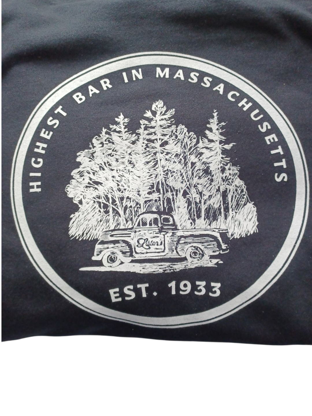 A white graphic on a dark background features a vintage truck in front of pine trees, labeled 